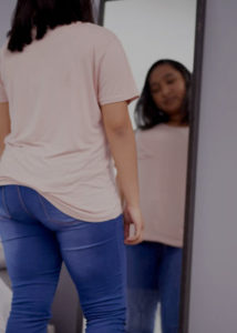 girl in pink shirt looking in mirror (2)