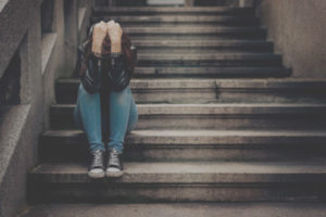 Woman crying on stairs