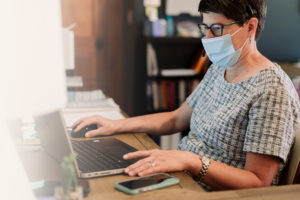 woman sitting at desk on computer