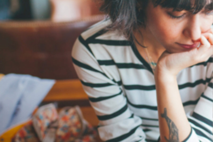 Woman sitting on couch looking at phone