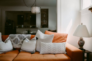 Picture of orange couch and pillows