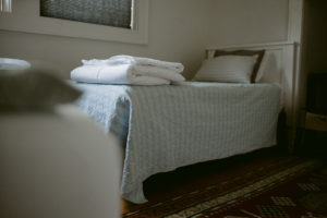 Bed with folded sheets on the end