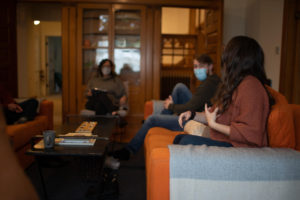 People sitting on orange couch