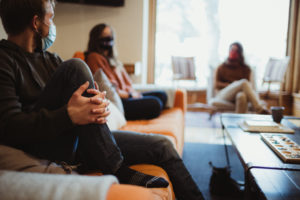 People sitting on an orange couch