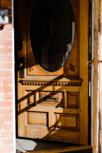 wooden door open to a house